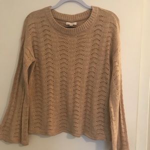 Cute sweater with bell sleeves.